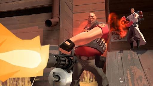 Capture d'écran du jeu Team Fortress 2, un jeu de tir populaire de Valve. Une personne tire avec son minigun tout en étant soignée par un médecin.