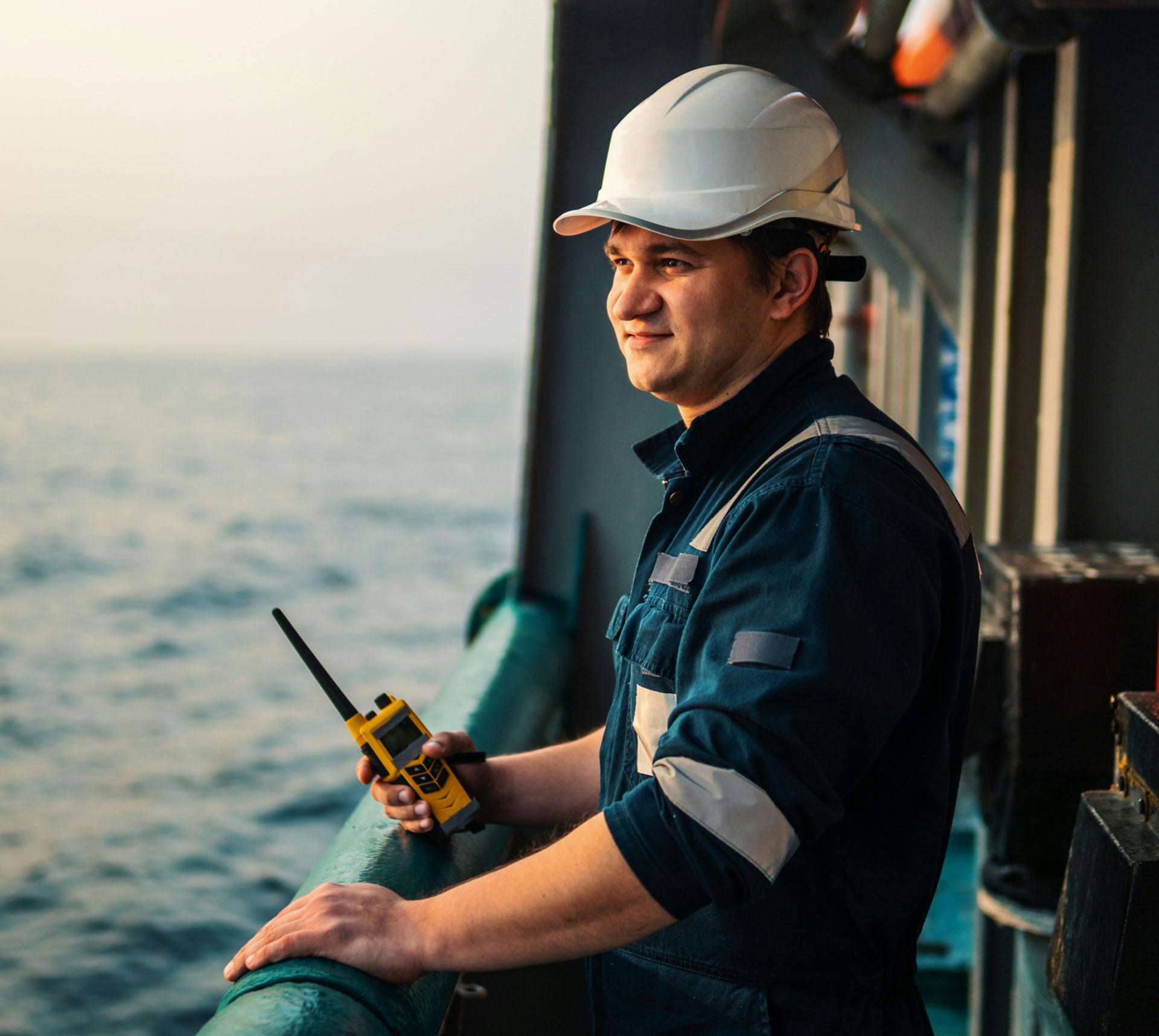 Worker on ship looking at the sea