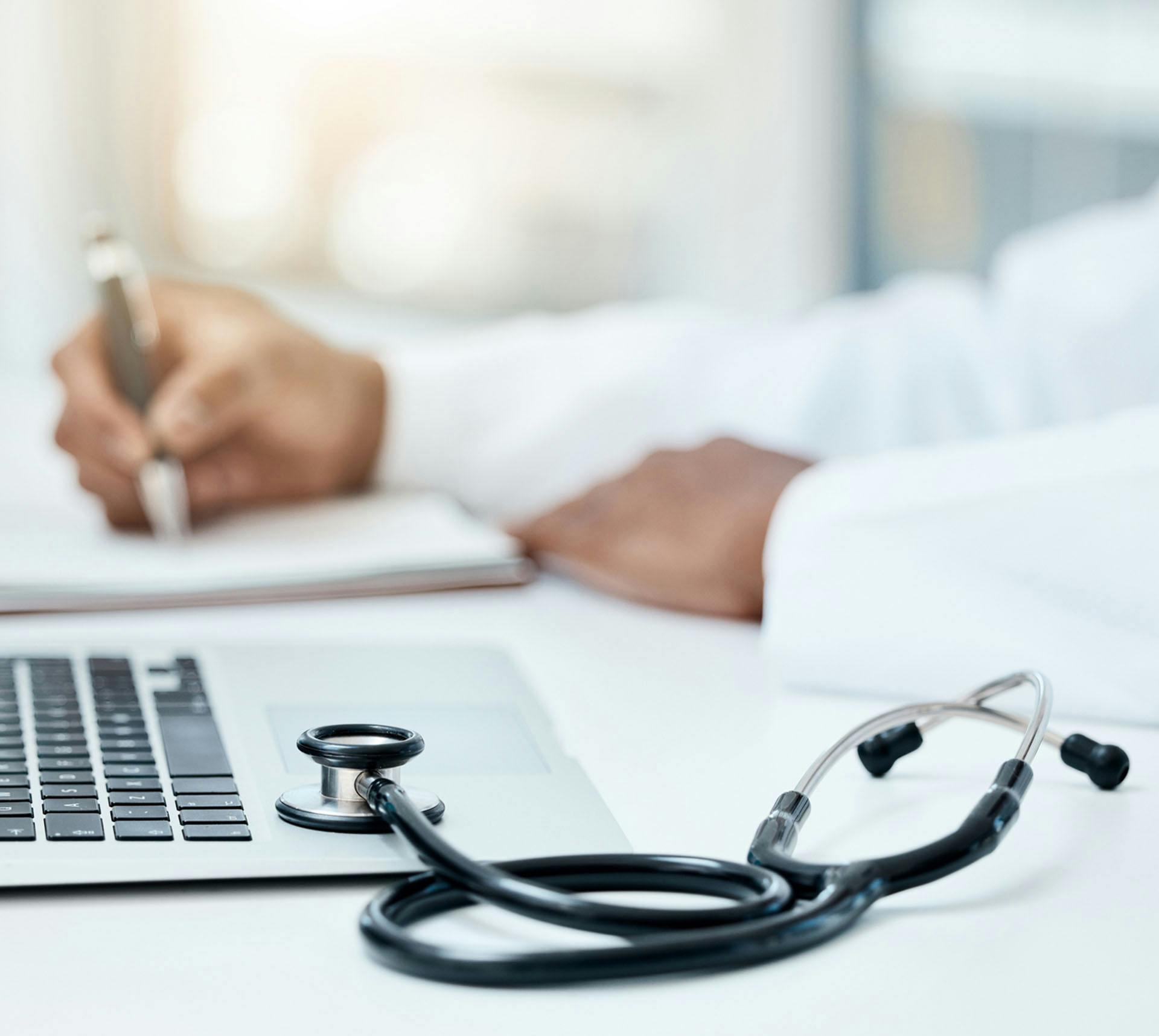 Doctor writing in notebook