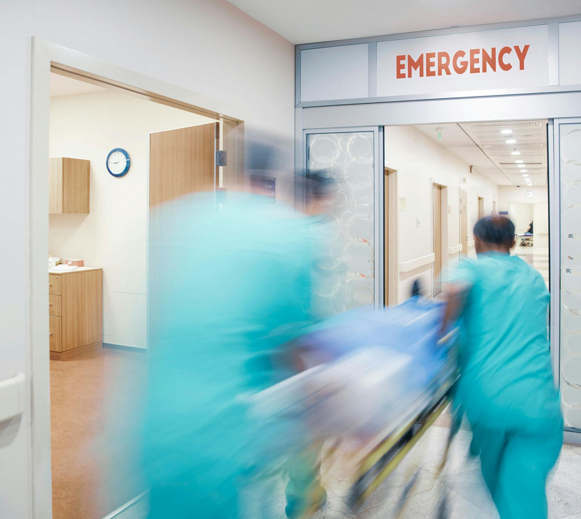 Emergency workers rushing patient to ER