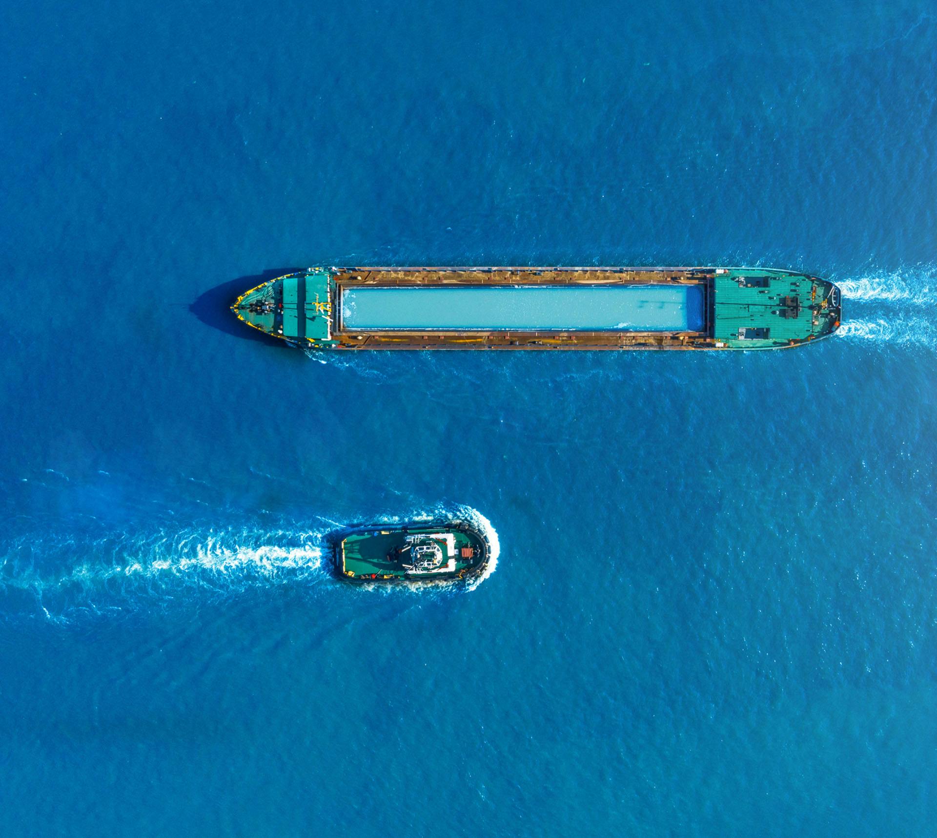 Large boat passing a smaller boat