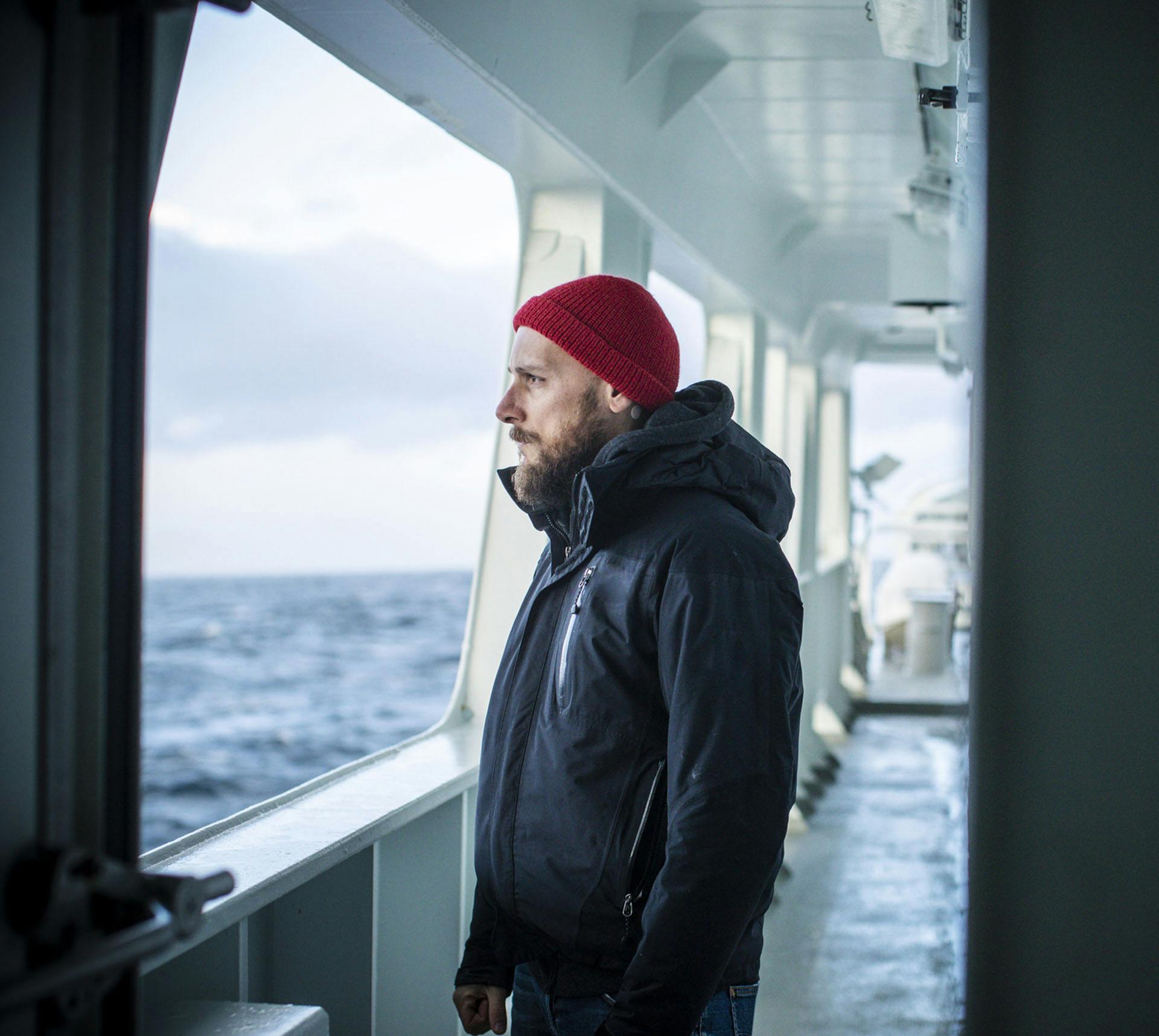 Man on boat looking out at the sea