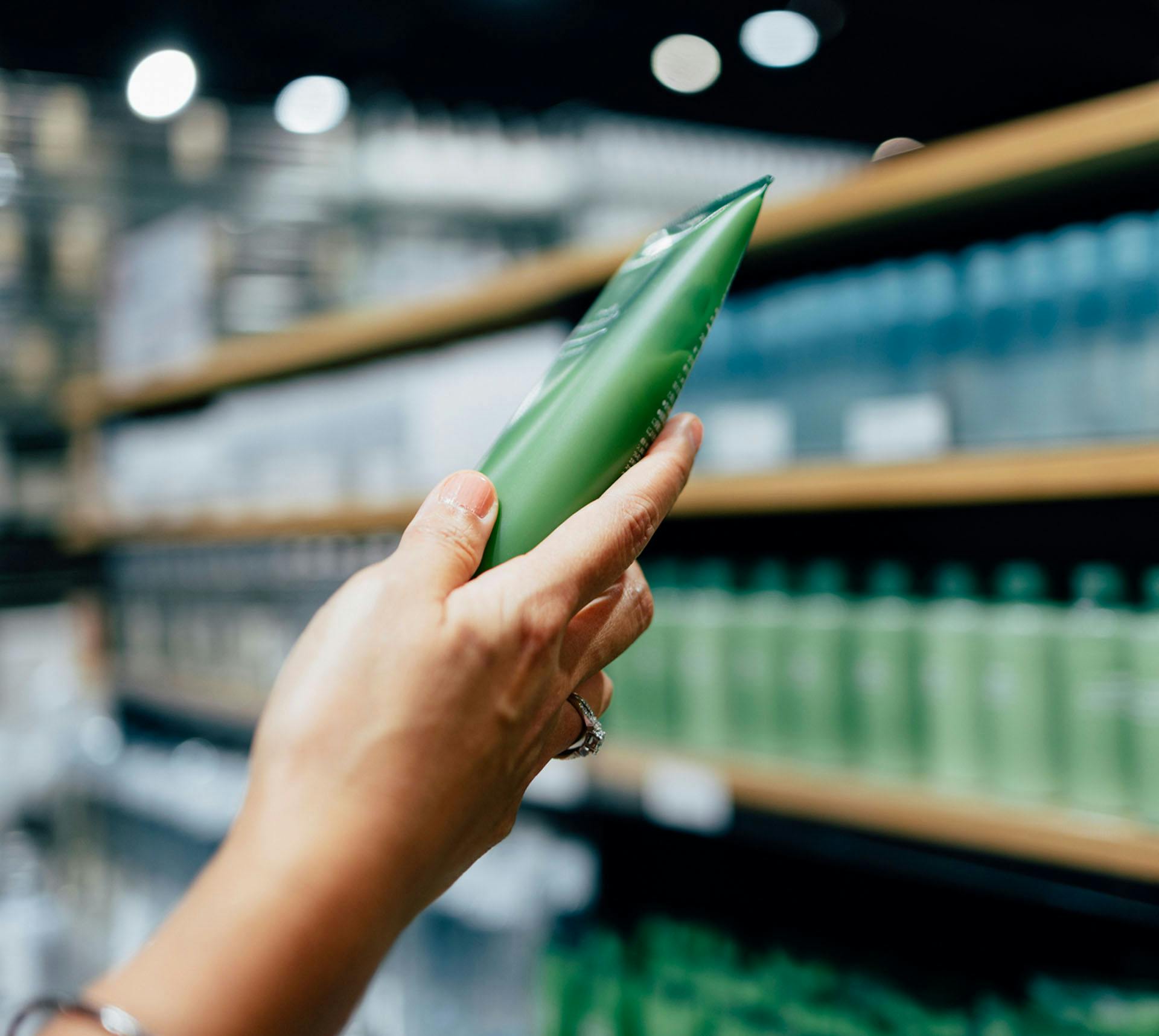Woman looking at product from store shelf