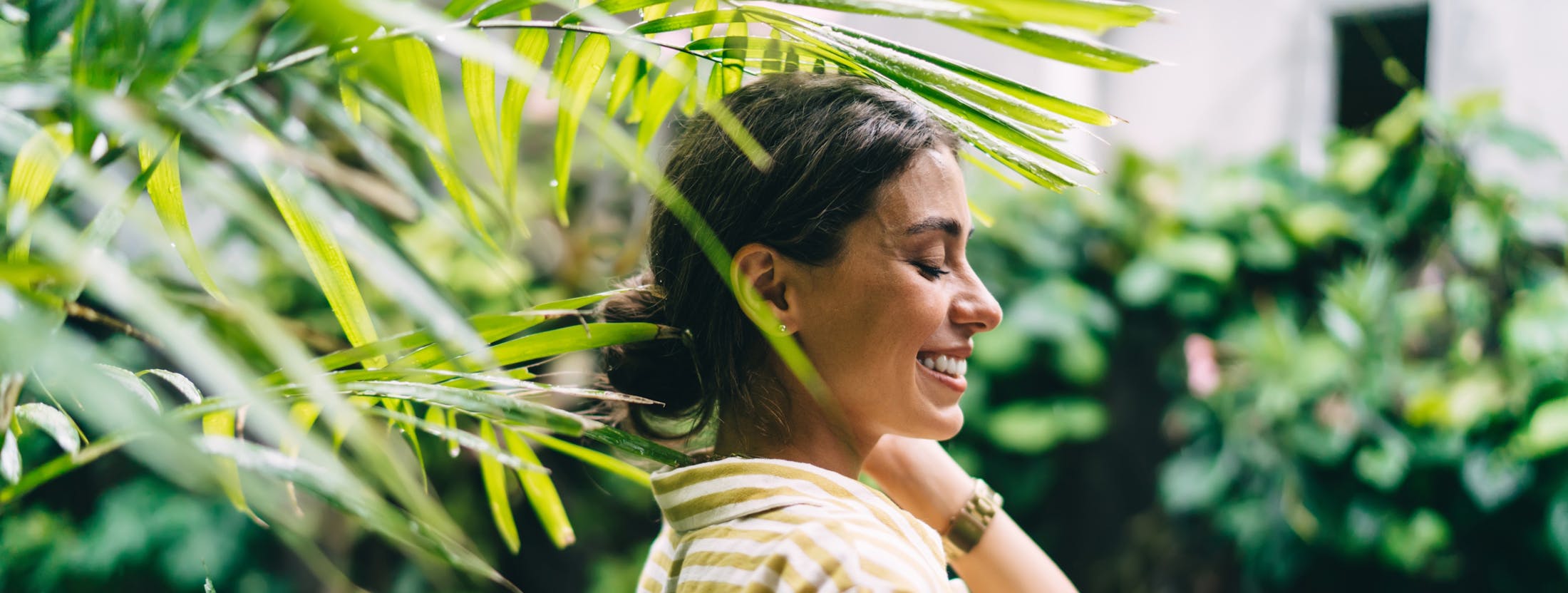 Woman standing by large plants