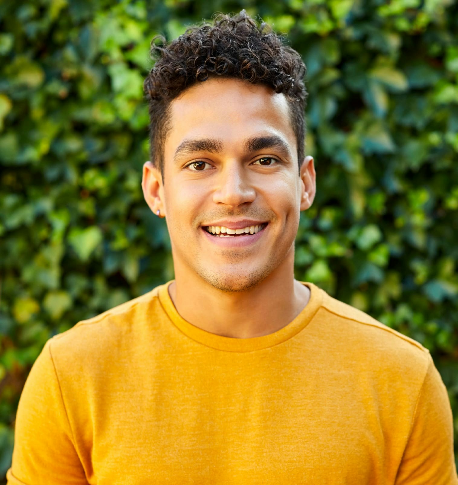 Man in yellow shirt smiling