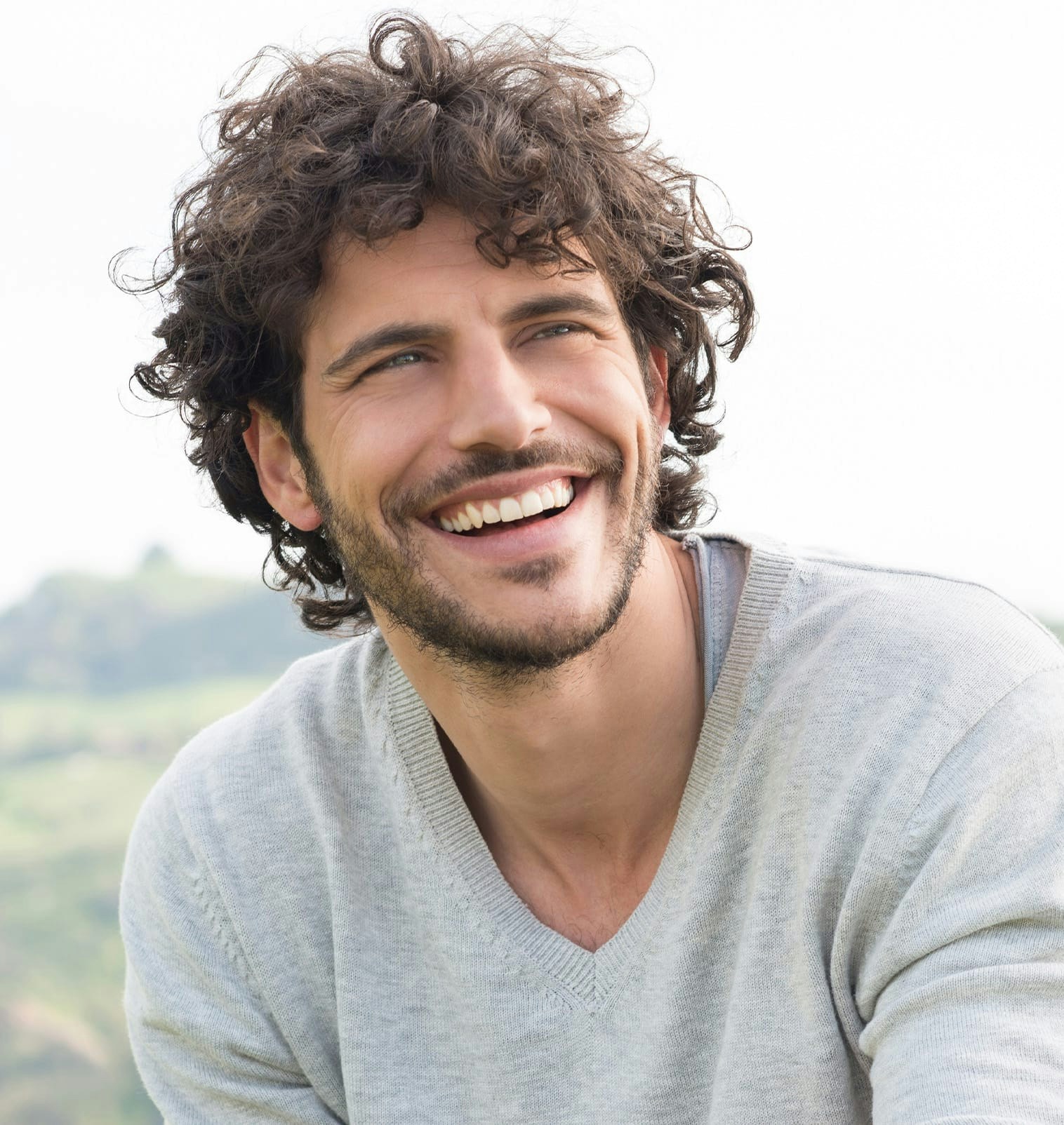 Man with facial hair smiling