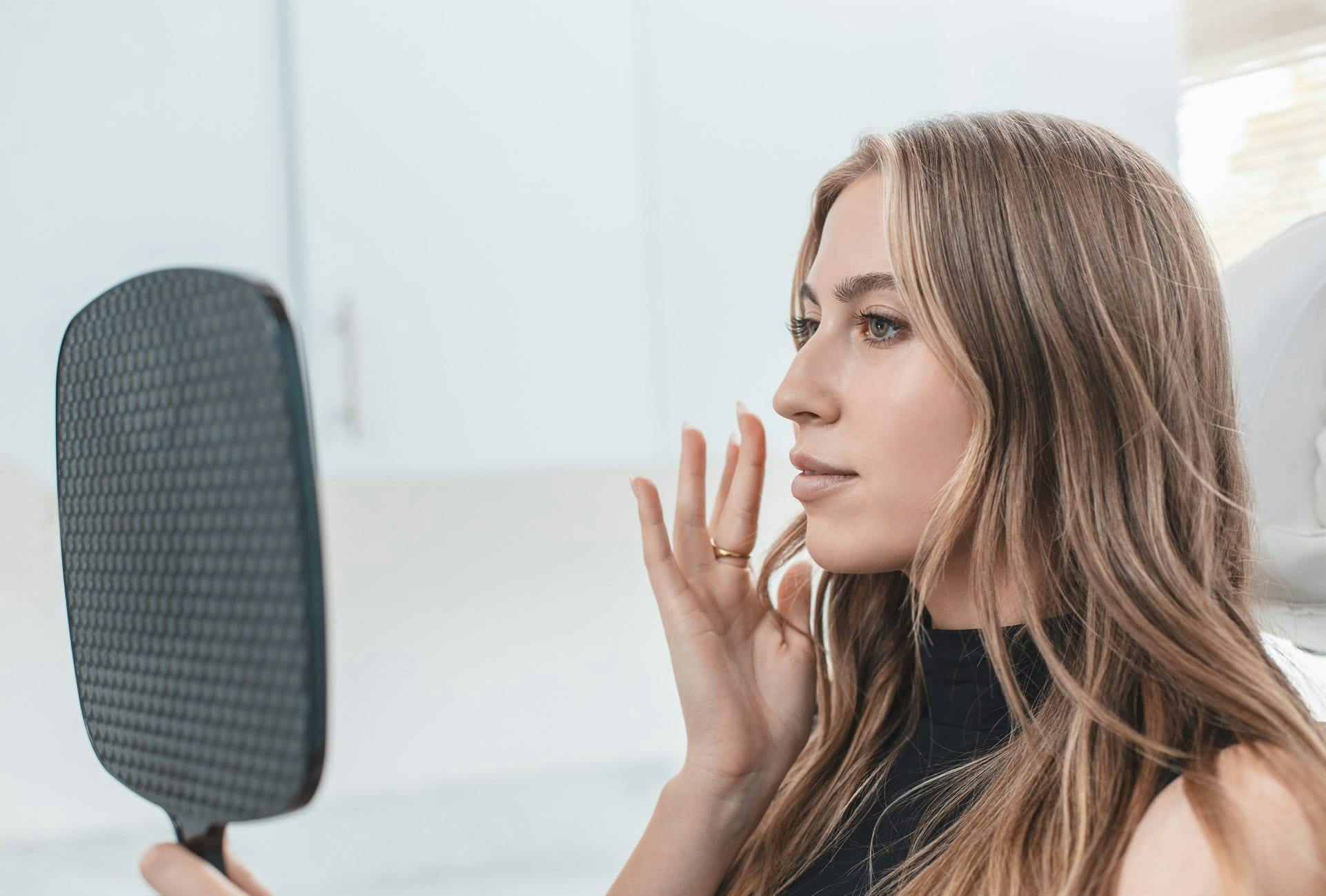 Woman looking at herself in mirror