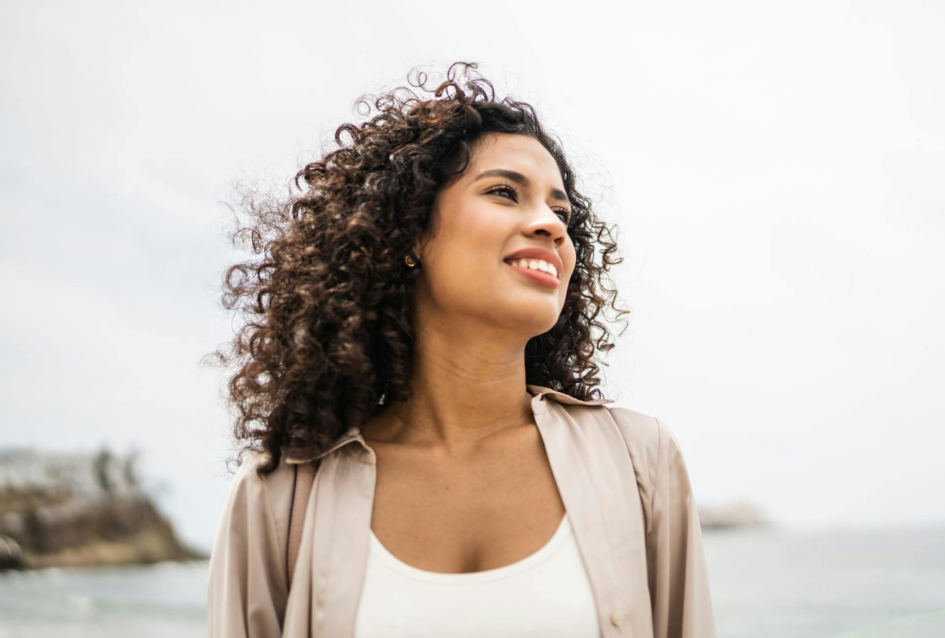 smiling woman on beach looking to her left