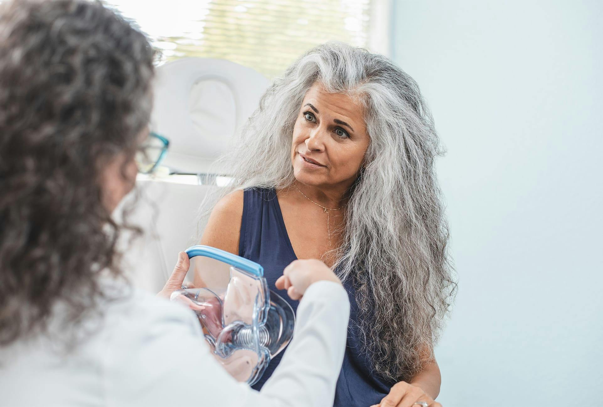 doctor educating patient with medical apparatus