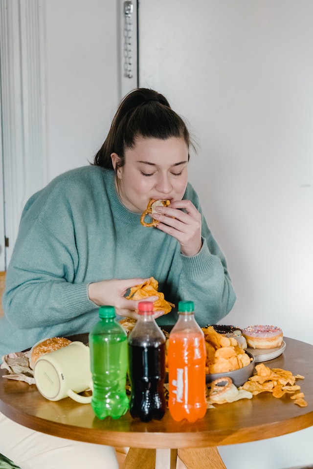 Woman eating junk food