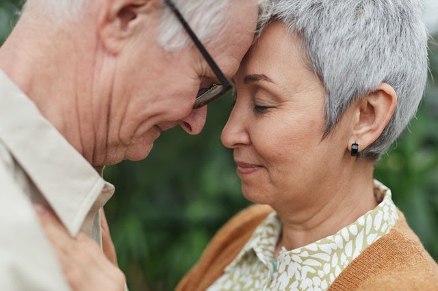 older couple smiling and putting forehead together