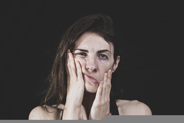 woman mushing her face with her hands