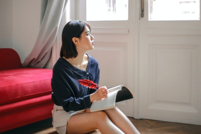 woman writing in book