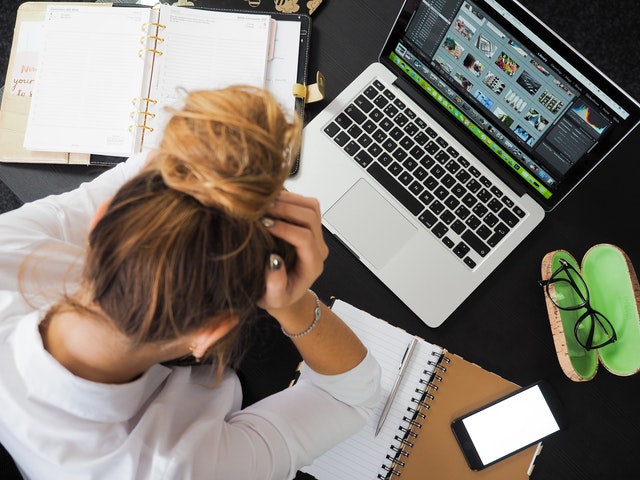 woman on computer stressing out