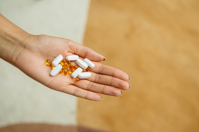 woman with a handful of pills