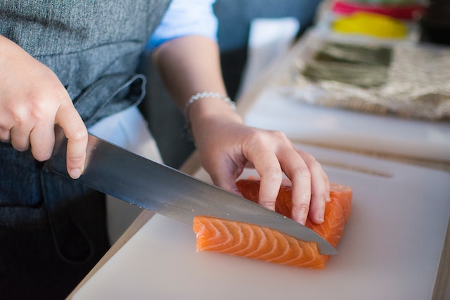 person slicing salmon