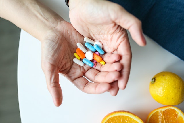 person holding a bunch of pills