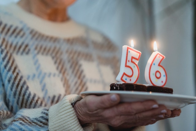 woman holding cake with candles