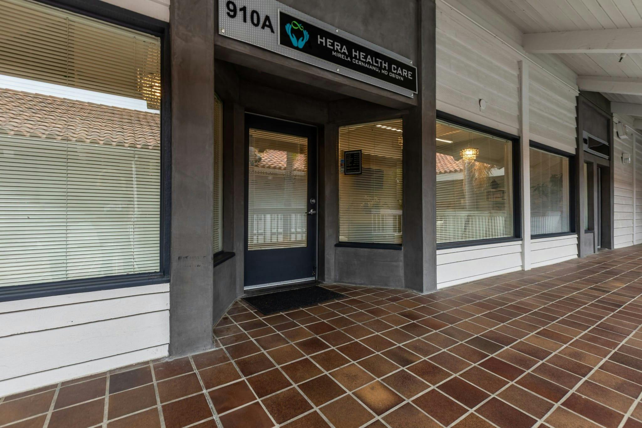 there is a building with a sign that says the office is open