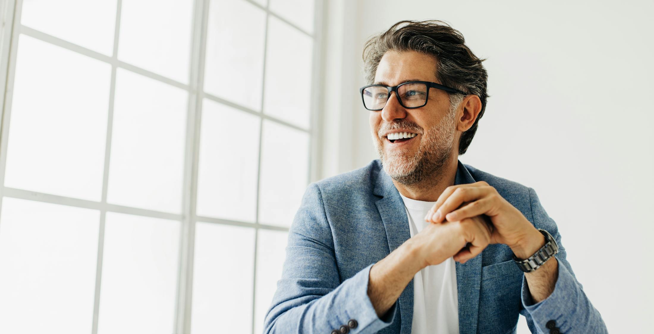 man in glasses smiling