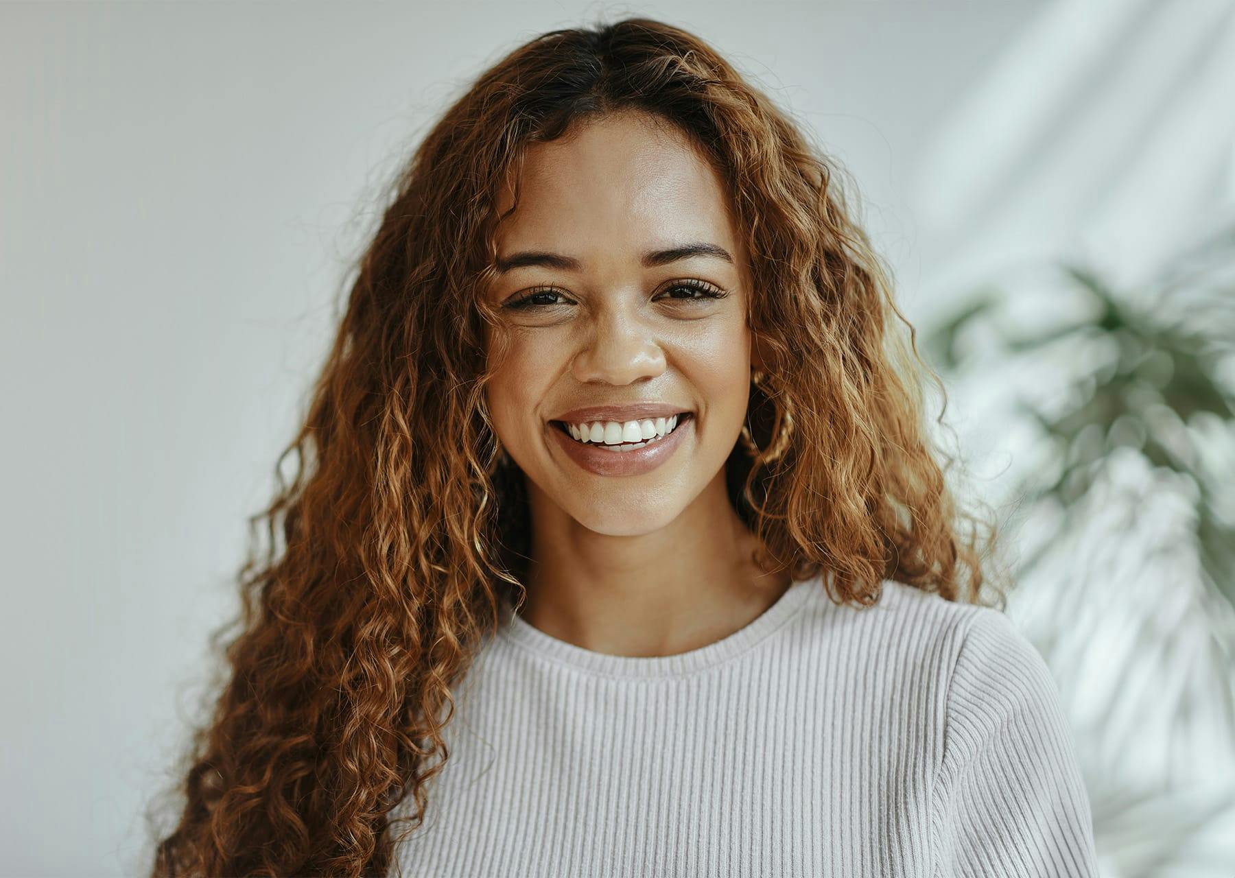 Smiling woman with long curly hair