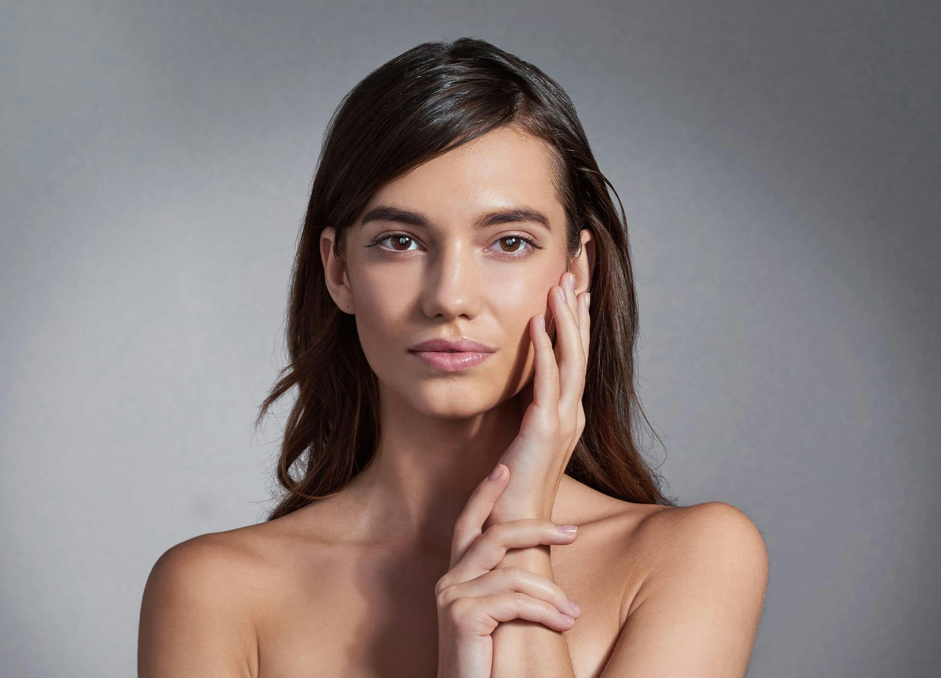Woman running hand over her cheek
