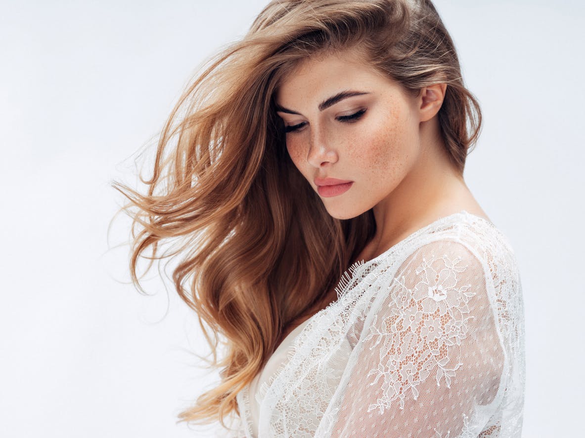 Beautiful woman with flowing hair as a result of Exosome treatements and PRP treatements for hair growth