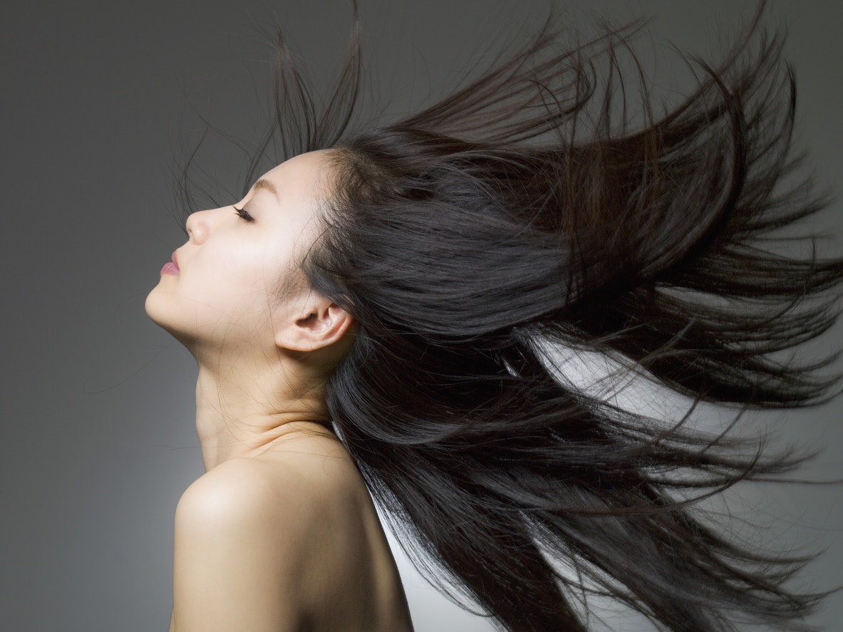 woman with beautiful healthy hair blowing in the air