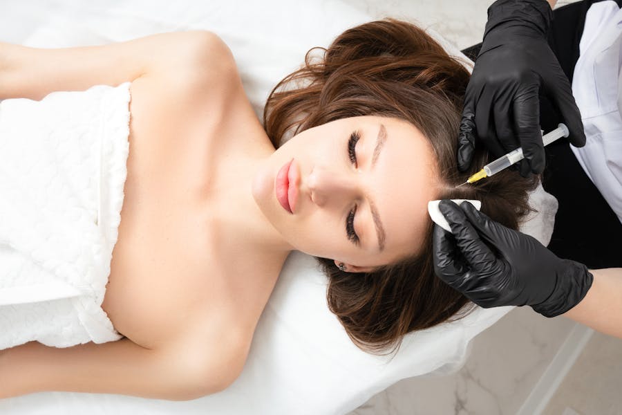 Woman reiving an Exosome & PRP treatement on her scalp in Thousand Oaks