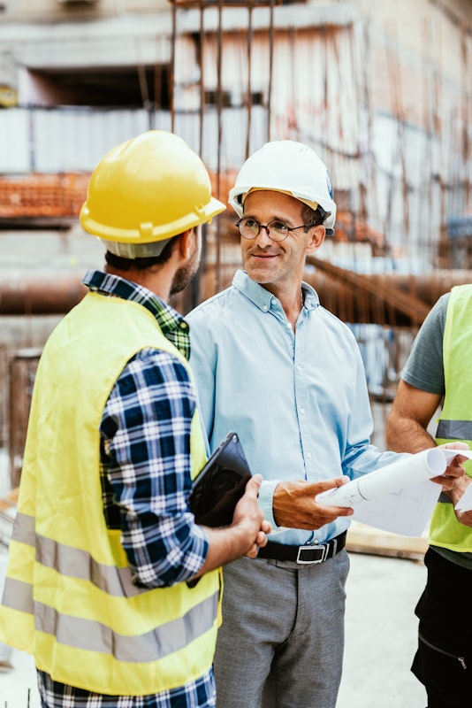 Engineers having meeting on construction site and discussing about project development