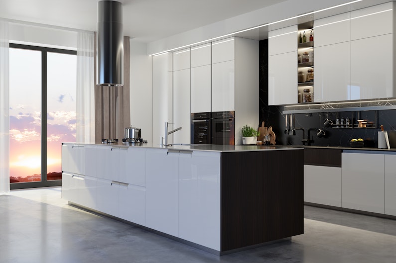 Luxury Kitchen Interior With Island, White Cabinets, Kitchen Utensils And Sunset View From The Window.