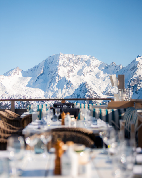 Sunny terrace in Courchevel with a view of the snow-covered mountains