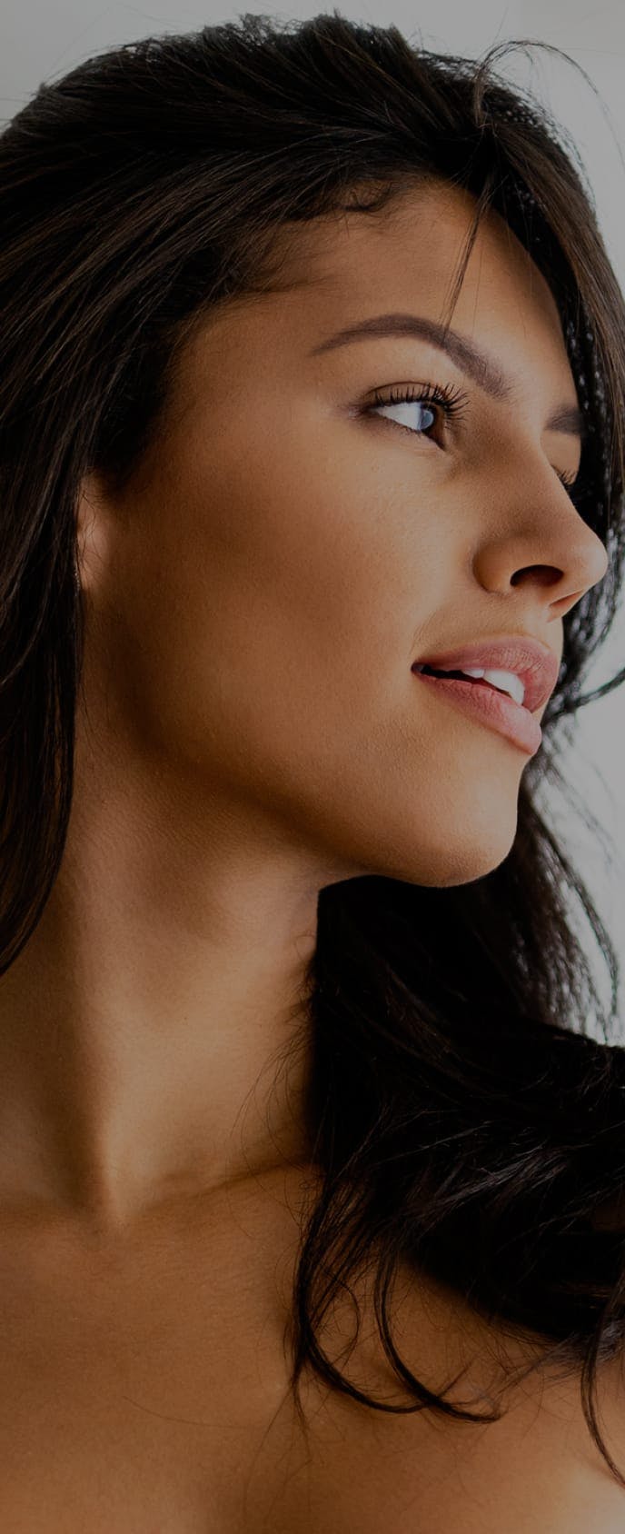 Smiling model looking to the side.