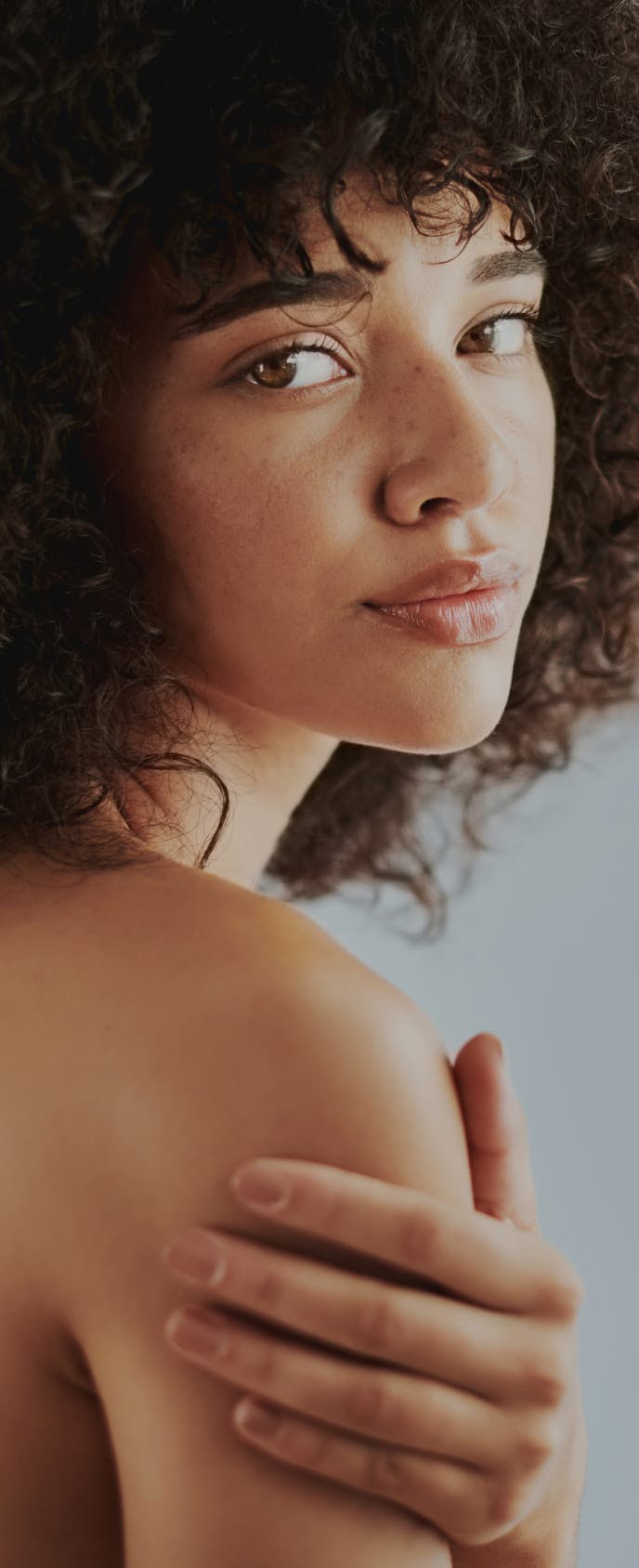 Woman posing looking over her shoulder.