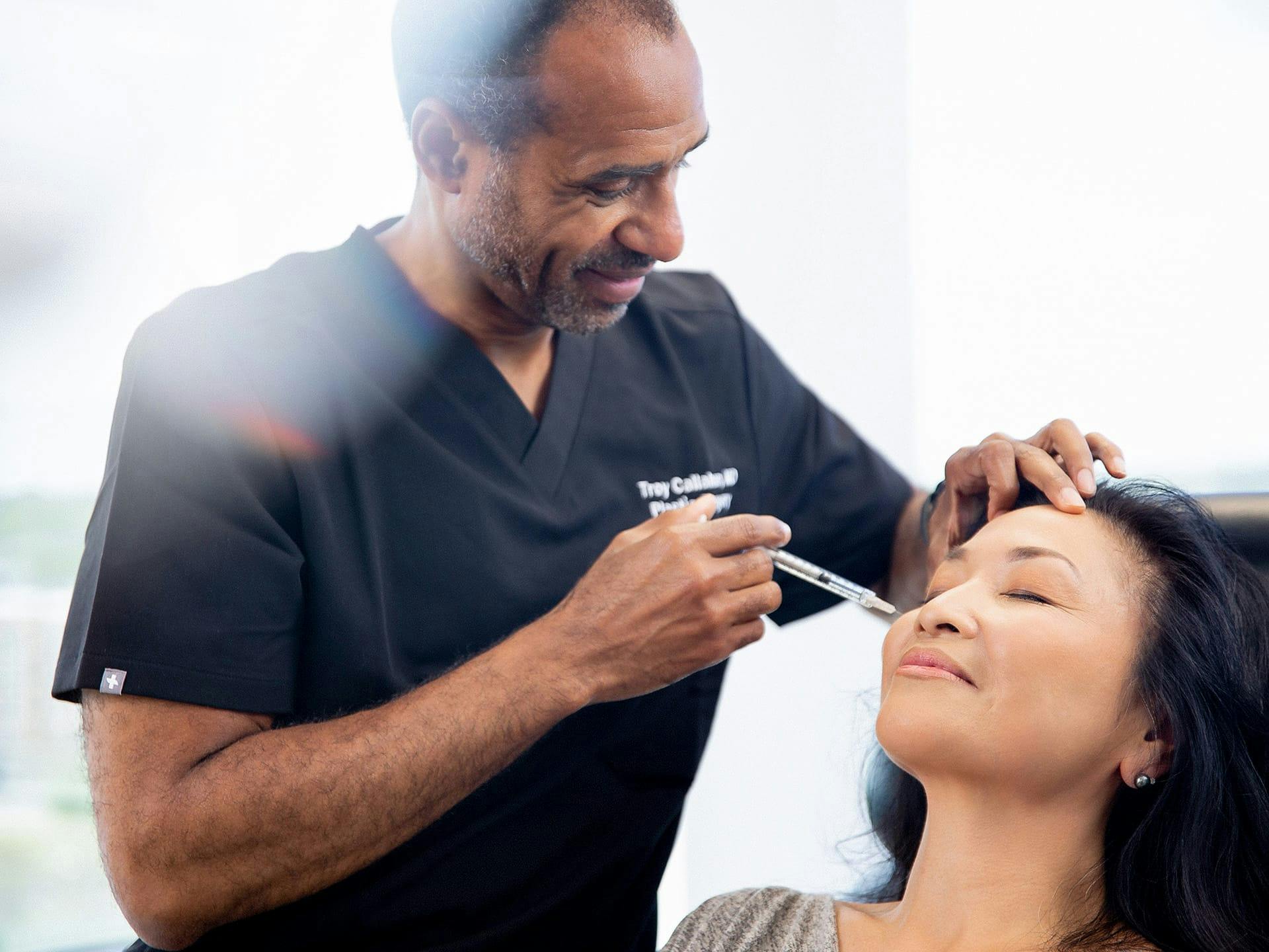 Dr. Callahan injecting botox into a patient's face