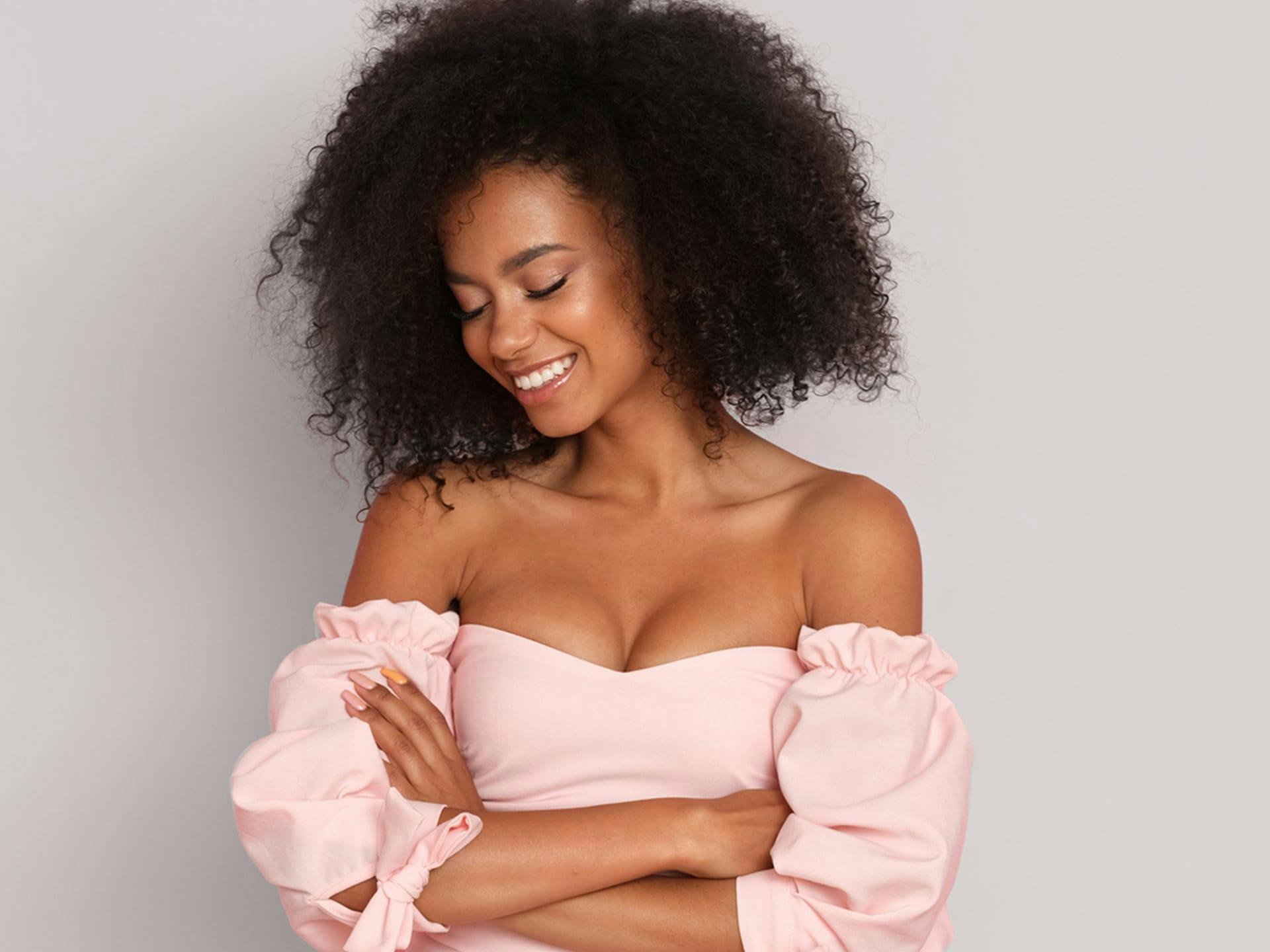 Woman in pink off the shoulder crop top.