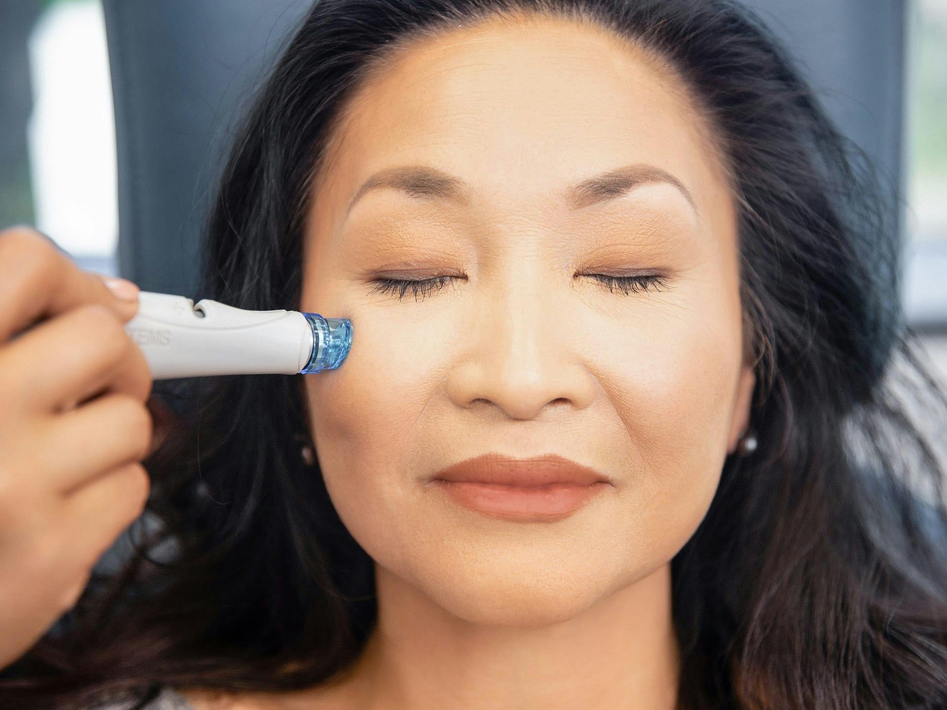 Woman receiving hydrafacial treatment in Englewood.