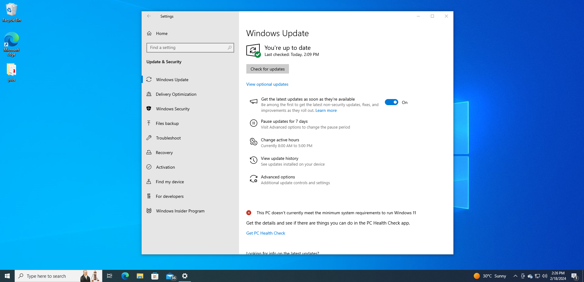 Screenshot of Windows Update settings showing the system is up to date, with a notification that the PC doesn't meet Windows 11 minimum requirements.