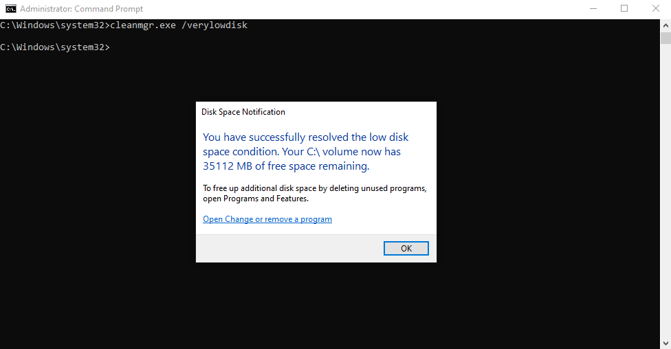 A command prompt window with a Disk Space Notification popup indicating successful resolution of low disk space, with 35112 MB of free space now available on the C: volume.