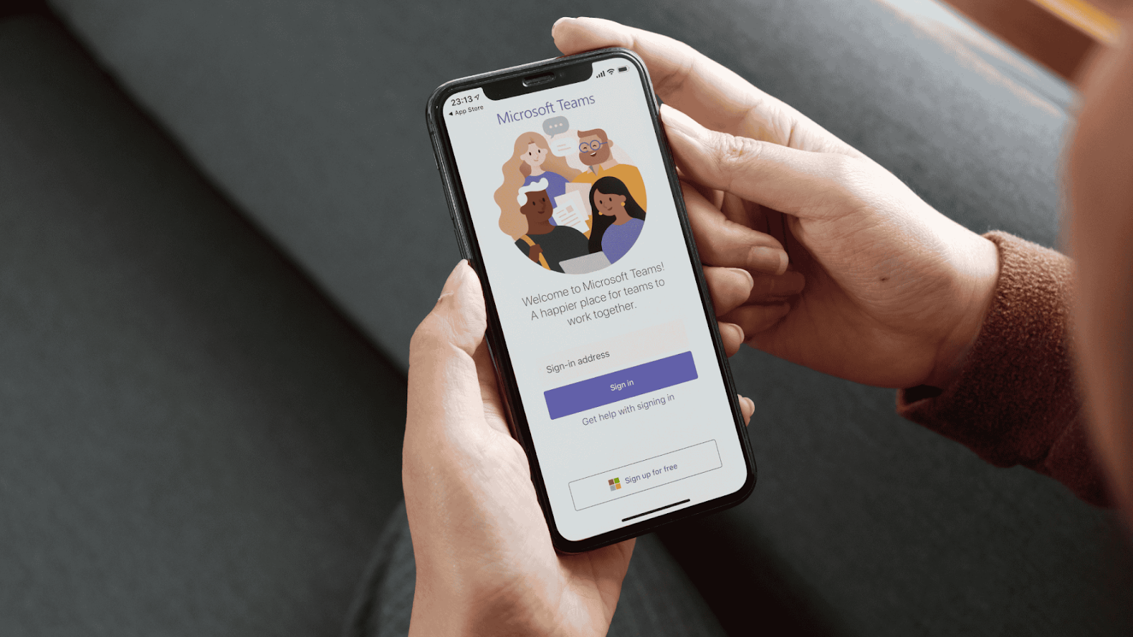 Hand holding smartphone with Teams application open