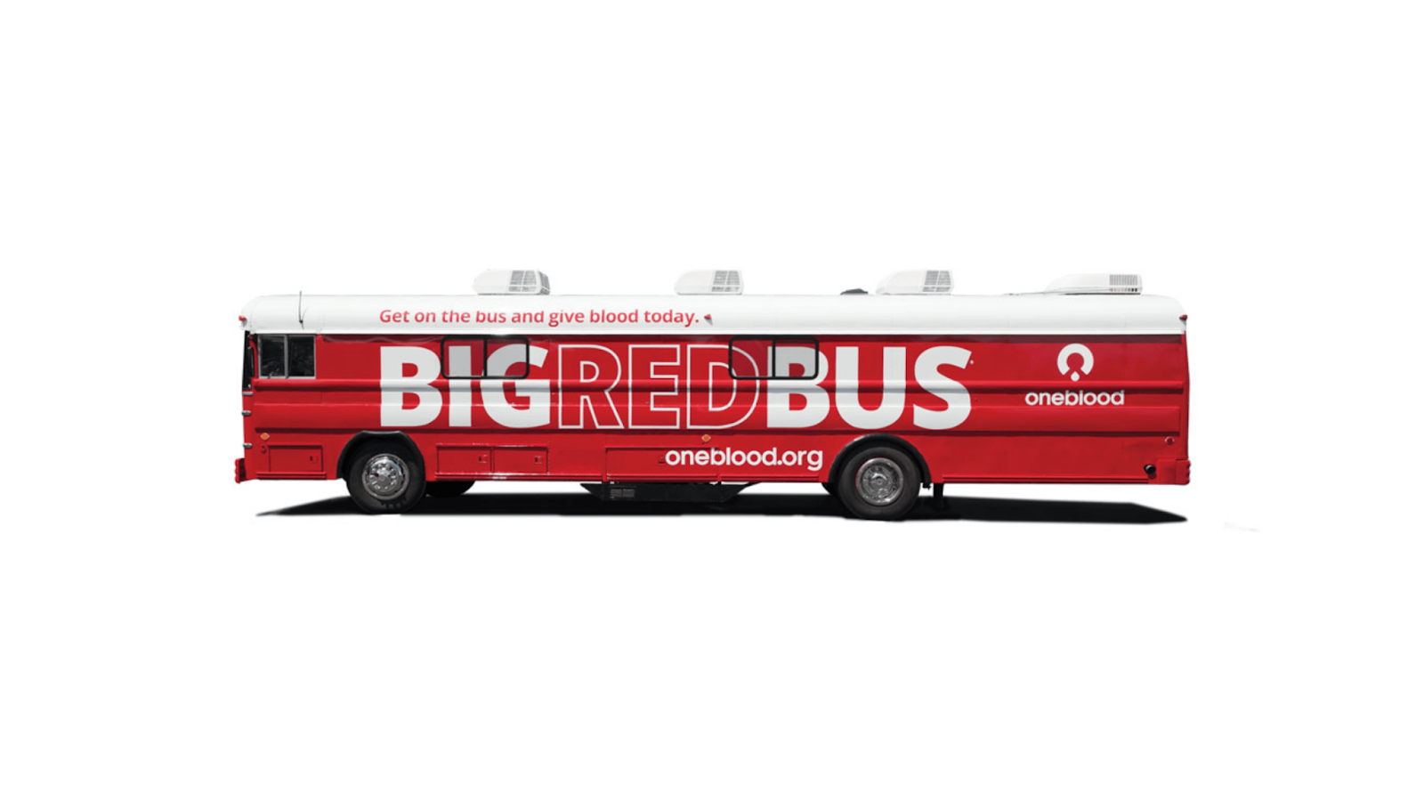 A mobile blood donation center with prominent branding parked in an overcast setting, ready to help save lives