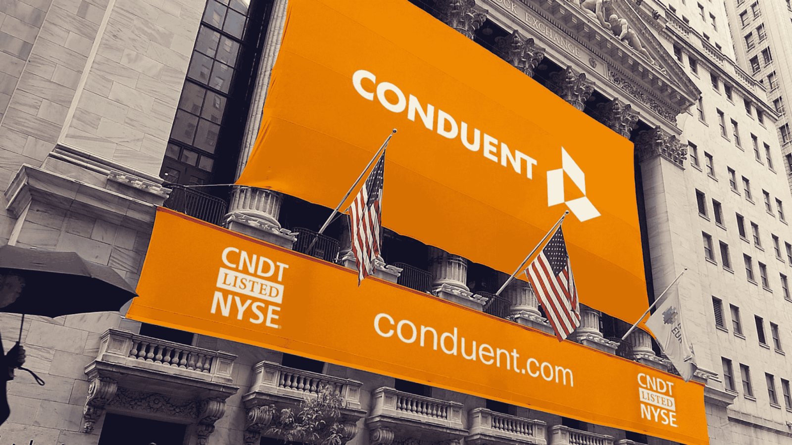 Conduent branding displayed on the New York Stock Exchange building with bright orange banners.