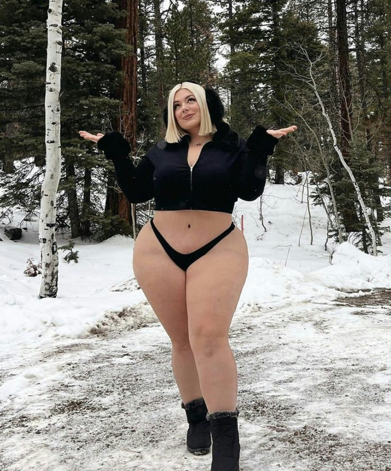 Woman in a sweater and bikini bottom in the snow