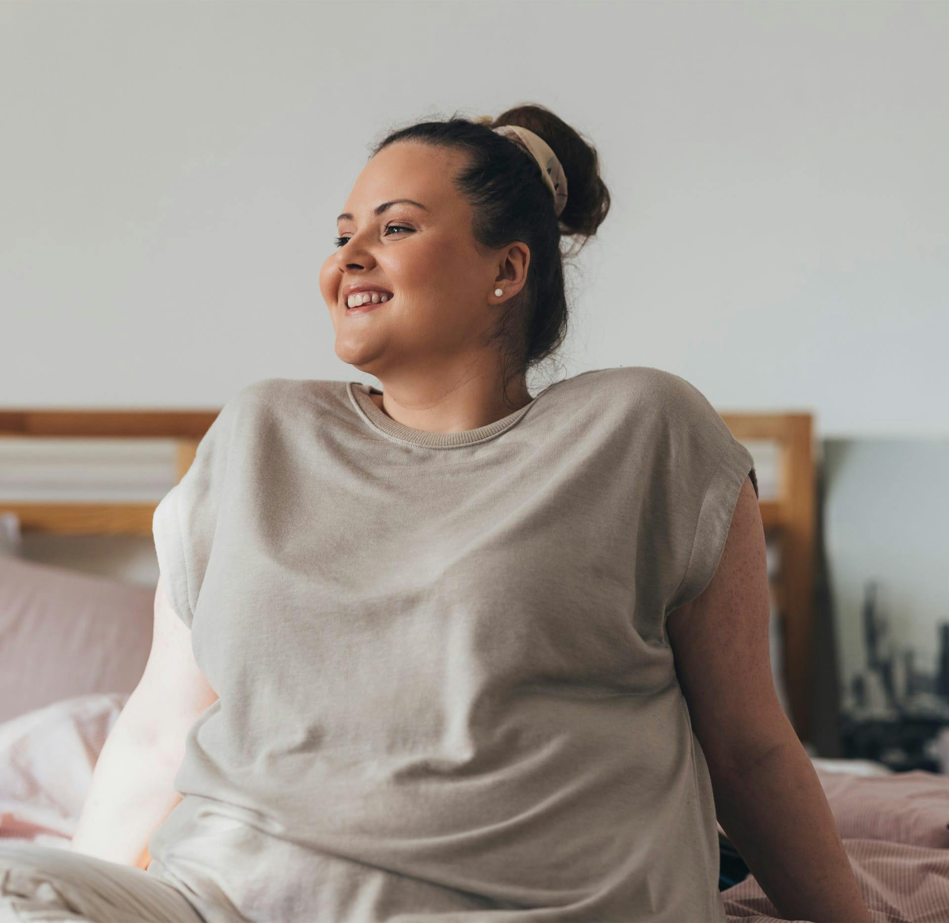 woman laying in bed smiling
