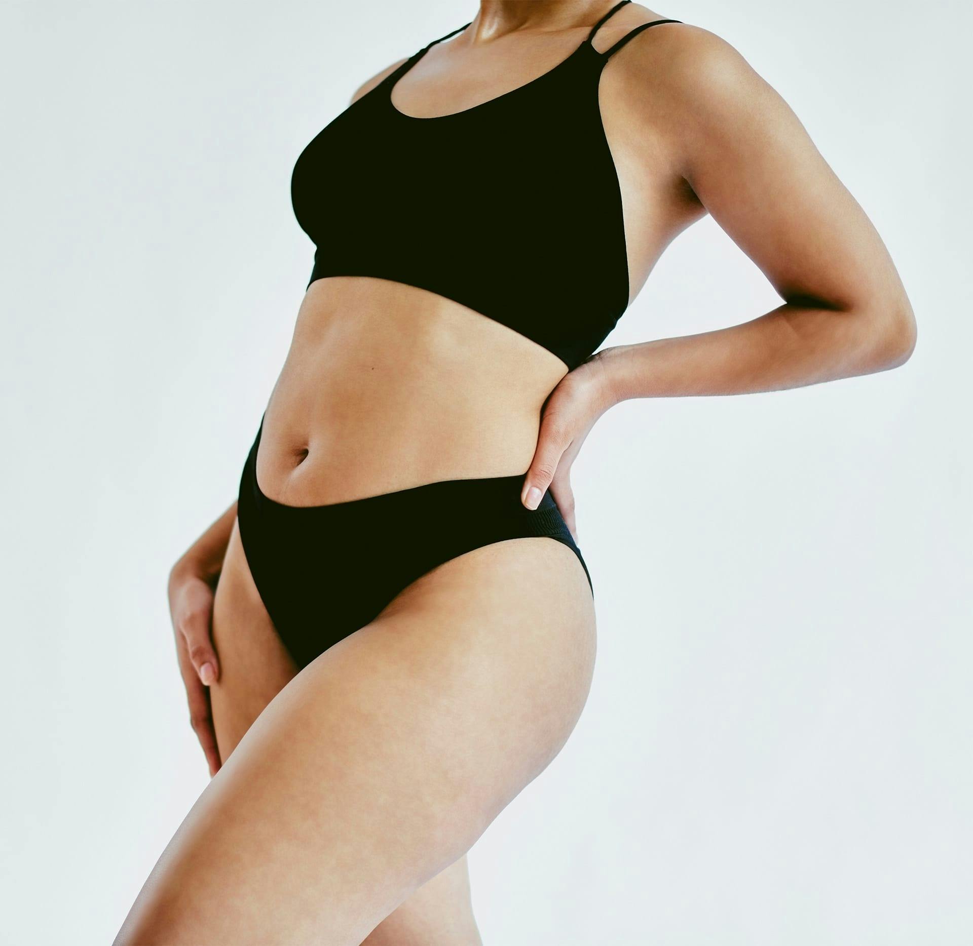womans body in black underwear and bra