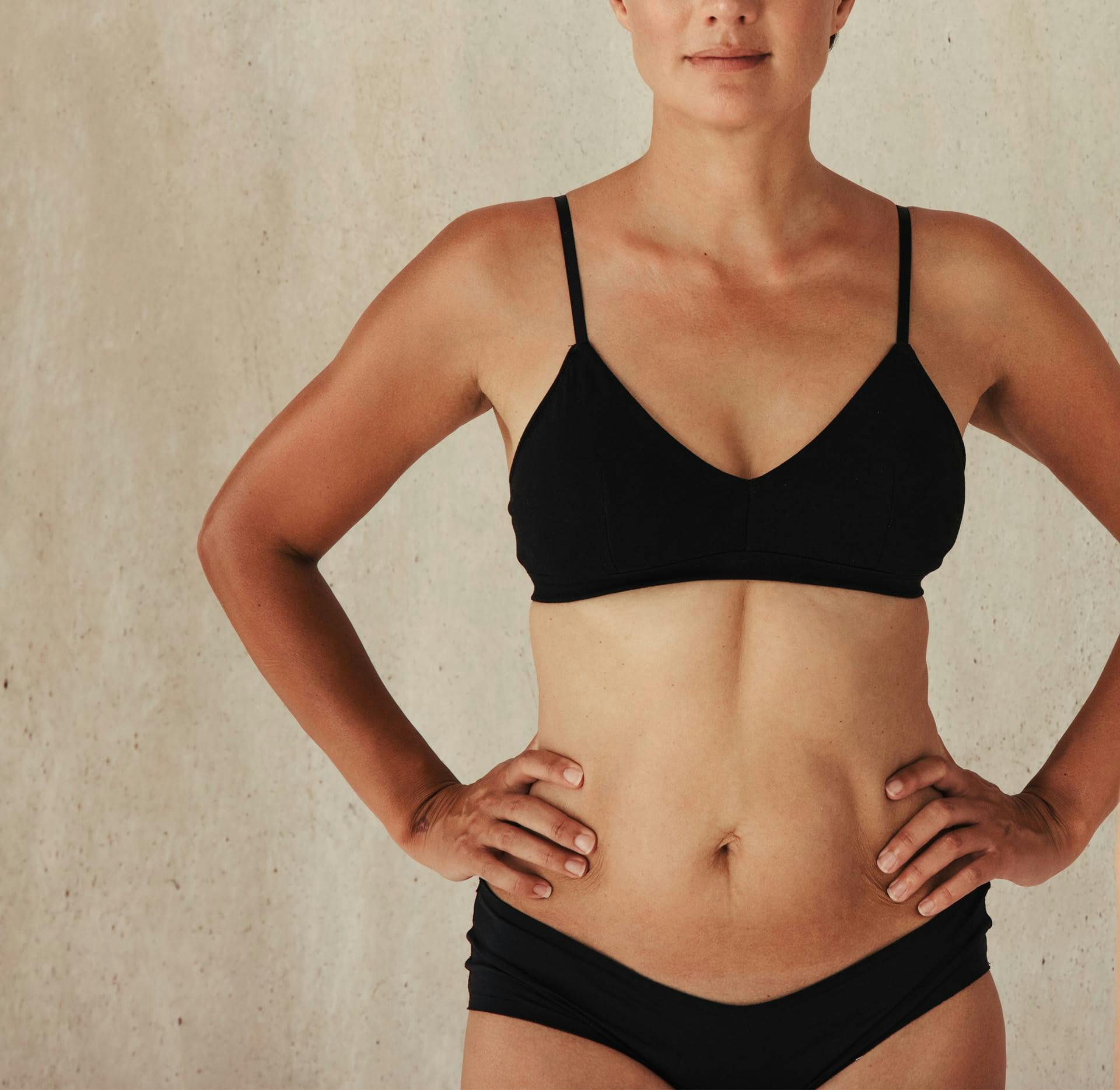 woman facing camera with hands on hips