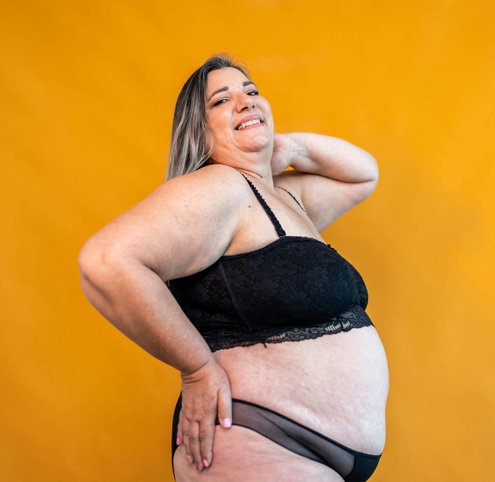 plus size woman side posing with hand on hip