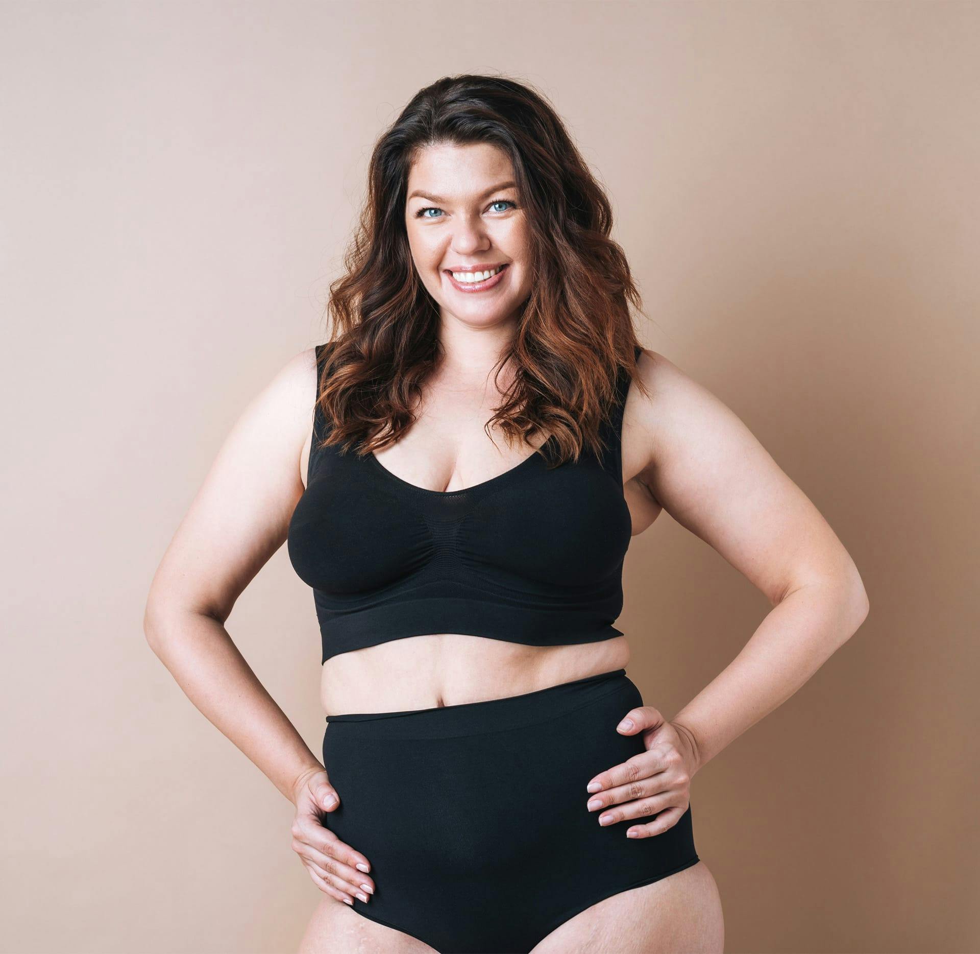 woman smiling with hands on hips