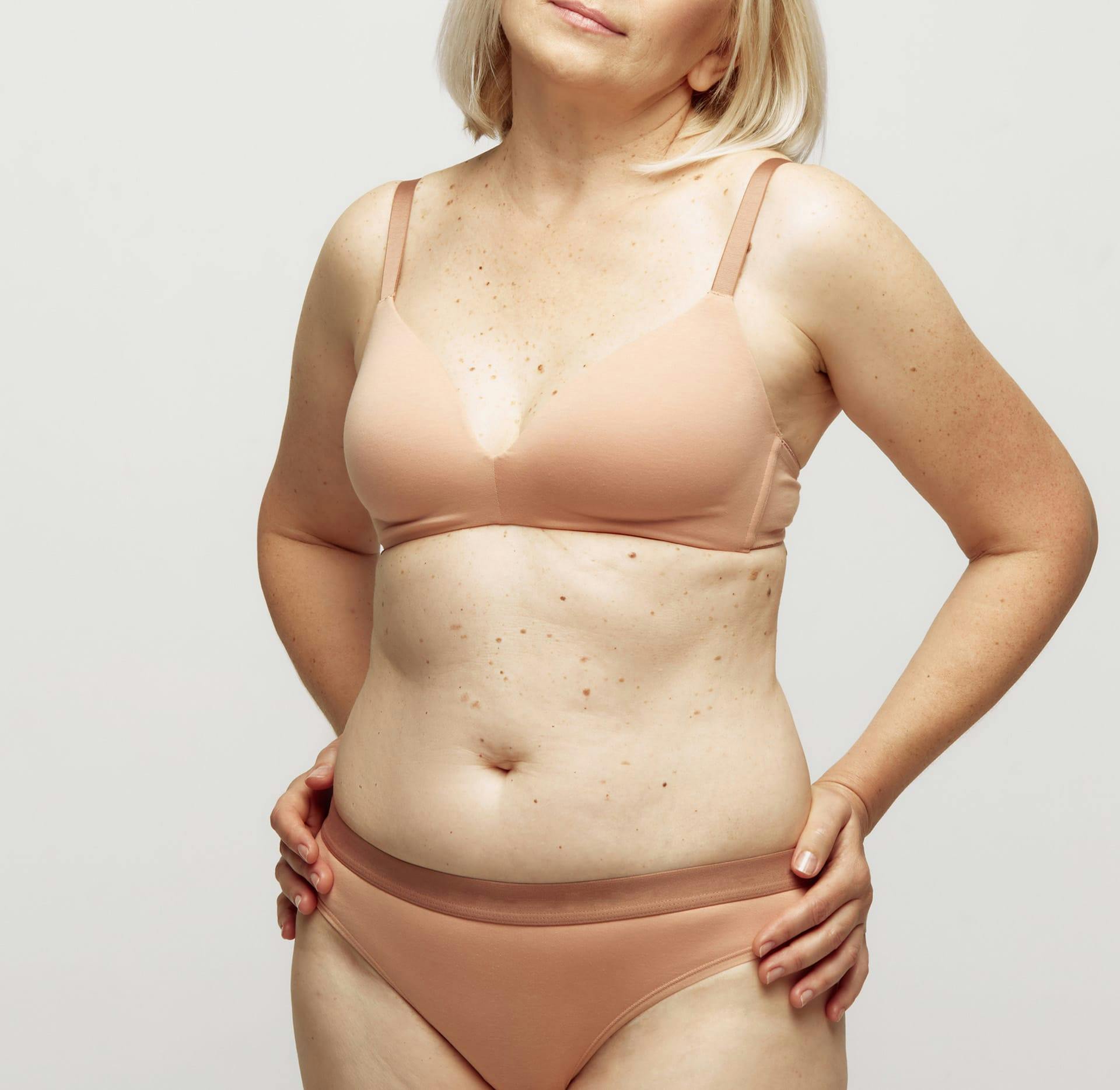 woman in beige underwear with hands on hips