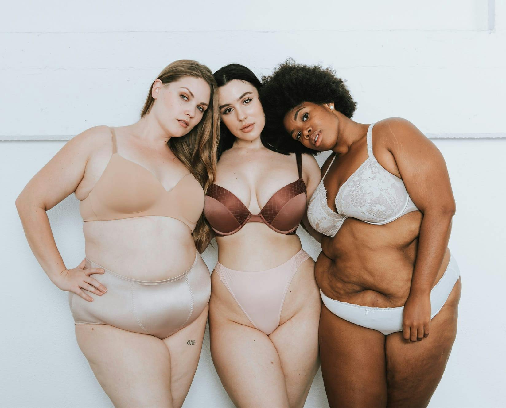 3 ladies in underwear hugging eachother